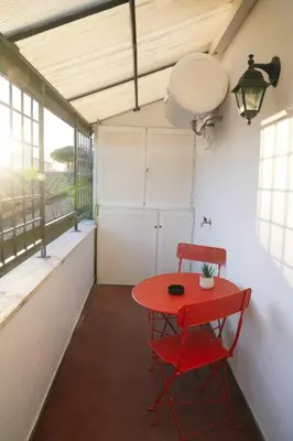 a red table and a red chair in a room at San Peter View in Rome