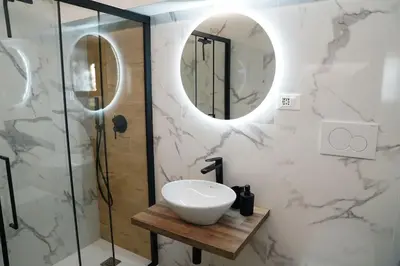 a bathroom with a sink and a mirror at San Peter View in Rome
