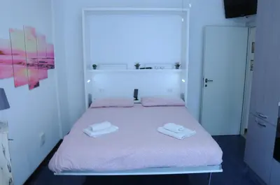 a bedroom with a bed with two towels on it at Appartamento 
