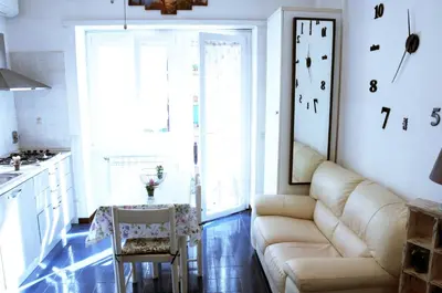a living room with a couch and a table at Appartamento 
