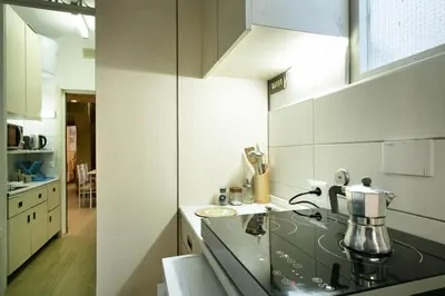 a kitchen with a sink and a stove top oven at Back to 70's-Modern and Terrace in Rome