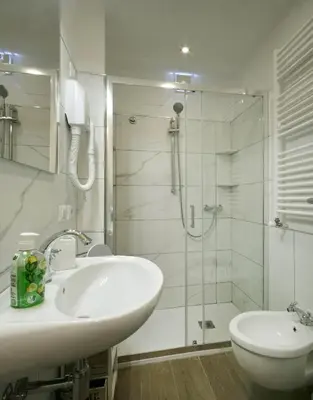 a white bathroom with a sink and a shower at Back to 70's-Modern and Terrace in Rome