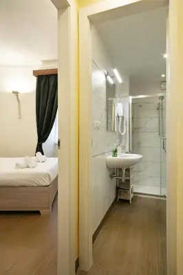a bathroom with a bed and a sink and a shower at Back to 70's-Modern and Terrace in Rome