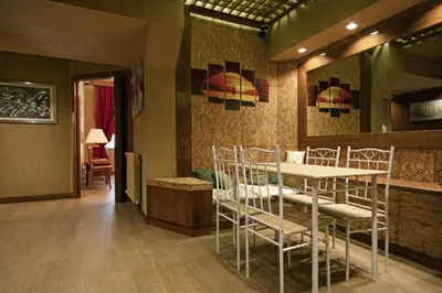 a dining room with a table and chairs in it at Back to 70's-Modern and Terrace in Rome