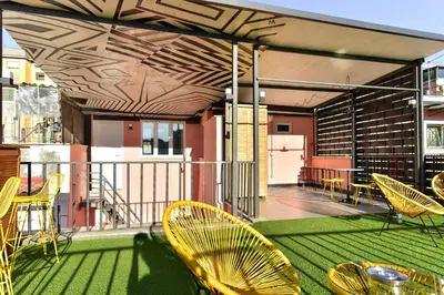 a balcony with chairs and tables on a building at FanfullArt in Rome