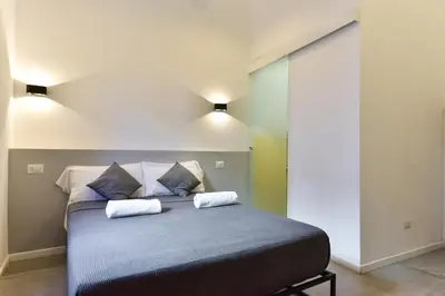 a bedroom with a bed with two pillows on it at FanfullArt in Rome