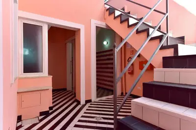 a staircase in a pink house with black and white floors at FanfullArt in Rome