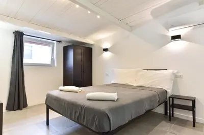 a bedroom with a bed with two white pillows on it at FanfullArt in Rome