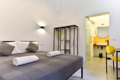 a bedroom with a bed with two white pillows on it at FanfullArt in Rome