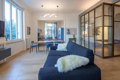 a living room with a blue couch with a white pillow at Luna's Apartment BuddyRent in Rome