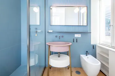 a bathroom with a stool and a sink and a mirror at Luna's Apartment BuddyRent in Rome