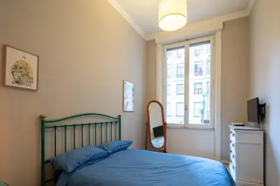 a bedroom with a bed and a window at Luna's Apartment BuddyRent in Rome