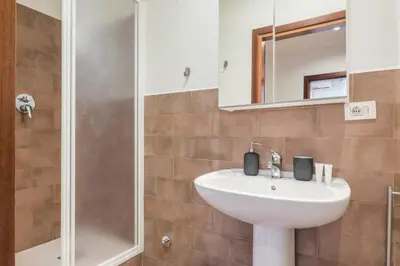 a bathroom with a sink and a shower at JOIVY Lovely Flats Next To Fontana di Trevi in Rome