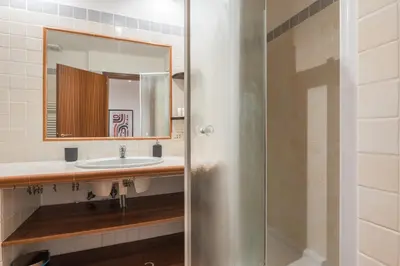 a bathroom with a sink and a mirror at JOIVY Lovely Flats Next To Fontana di Trevi in Rome