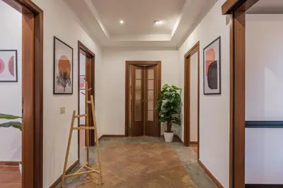 a hallway with wooden doors and a potted plant at JOIVY Lovely Flats Next To Fontana di Trevi in Rome