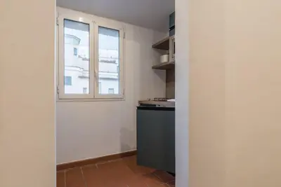 an empty kitchen with a window and a counter at JOIVY Lovely Flats Next To Fontana di Trevi in Rome