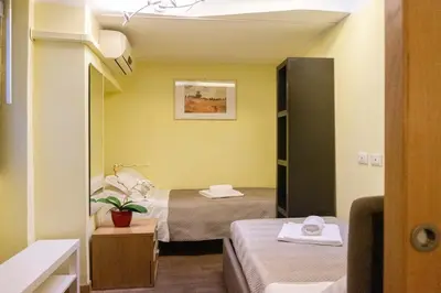a small room with two beds and a mirror at Borgo Vittorio - exclusive residence in the heart of Rome in Rome