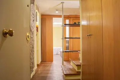 a hallway leading to a kitchen with a door open at Borgo Vittorio - exclusive residence in the heart of Rome in Rome