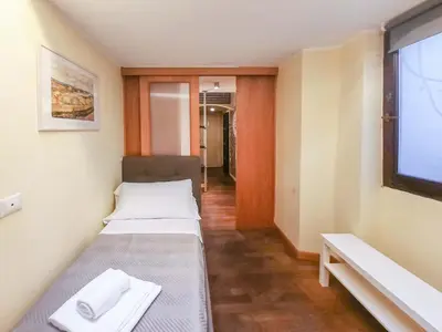 a small room with two beds and a flat screen tv at Borgo Vittorio - exclusive residence in the heart of Rome in Rome
