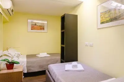 a room with two beds and a mirror at Borgo Vittorio - exclusive residence in the heart of Rome in Rome