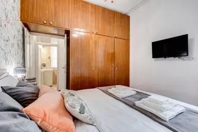 a bedroom with a bed with a tv on the wall at BDC - Penthouse Brancaccio in Rome