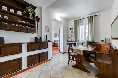 a kitchen with a table and a dining room at BDC - Penthouse Brancaccio in Rome