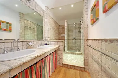 a bathroom with two sinks and a shower at Piscinula in Rome