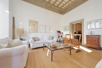 a living room with a white couch and a table at Piscinula in Rome
