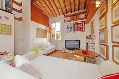 a living room with a white couch and a table at Spagna in Rome