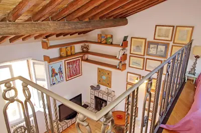 a staircase in a home with paintings on the wall at Spagna in Rome