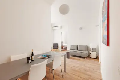 a dining room and living room with a table and chairs at Vatican Lovely 2BR Apartment with Terrace in Rome