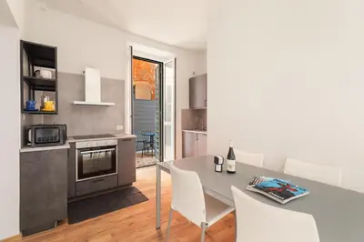 a kitchen with a table and chairs in a room at Vatican Lovely 2BR Apartment with Terrace in Rome
