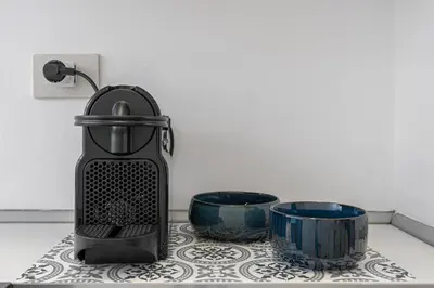 a grater sitting next to two bowls on a counter at Flaminio Charme Apartment in Rome