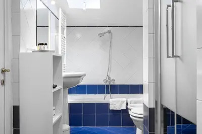 a bathroom with a toilet and a sink and a tub at Flaminio Charme Apartment in Rome
