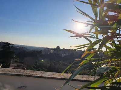 a view of the sun setting over a city at Appartamento 