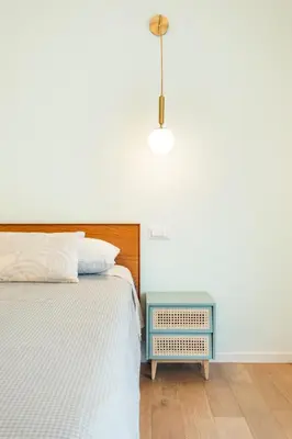 a bedroom with a bed and a blue night stand at Supreme Apartments Vaticano in Rome