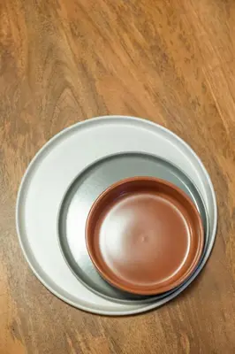 a white plate on a table with a brown sauce at Supreme Apartments Vaticano in Rome