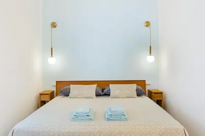 a bedroom with a bed with two towels on it at Supreme Apartments Vaticano in Rome