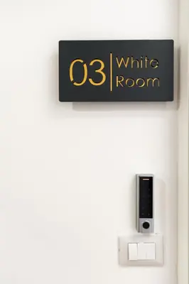 a sign for a white room on a wall at Supreme Apartments Vaticano in Rome