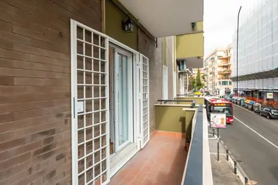 a building with a window on the side of a street at Supreme Apartments Vaticano in Rome
