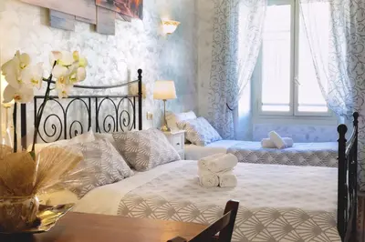 a bedroom with a bed with a teddy bear on it at Rossana House in Rome