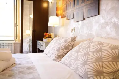 a bedroom with a bed and a table with a lamp at Rossana House in Rome