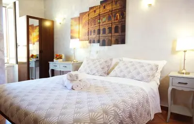 a bedroom with a white bed with towels on it at Rossana House in Rome