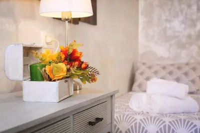 a bouquet of flowers on a counter in a bathroom at Rossana House in Rome