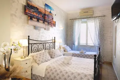 a bedroom with two beds and a window at Rossana House in Rome