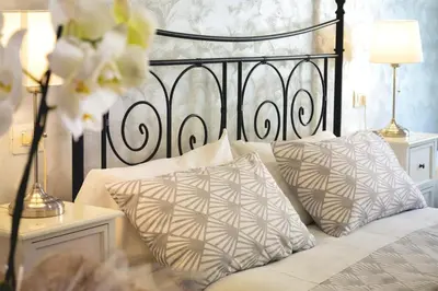a bedroom with a black and white bed with pillows at Rossana House in Rome