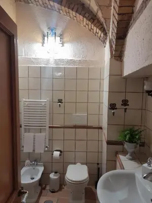 a bathroom with a toilet and a sink at DOMUS GELSOMINO in Rome