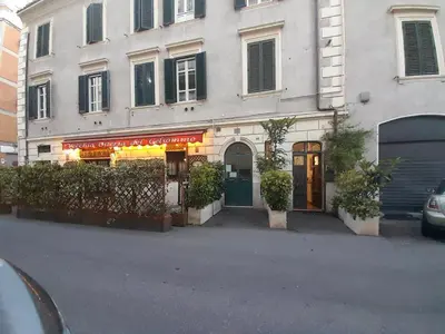 a building with a store on the side of a street at DOMUS GELSOMINO in Rome