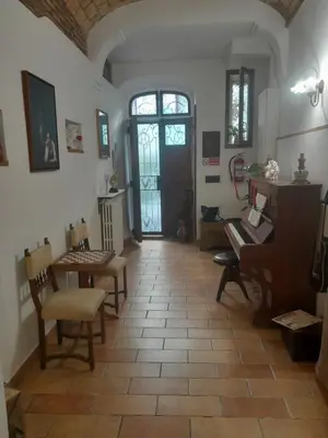 a room with a table and chairs and a desk at DOMUS GELSOMINO in Rome
