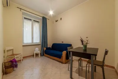 a living room with a blue couch and a table at GuestHost - Piazzale delle Provincie Apartment in Rome